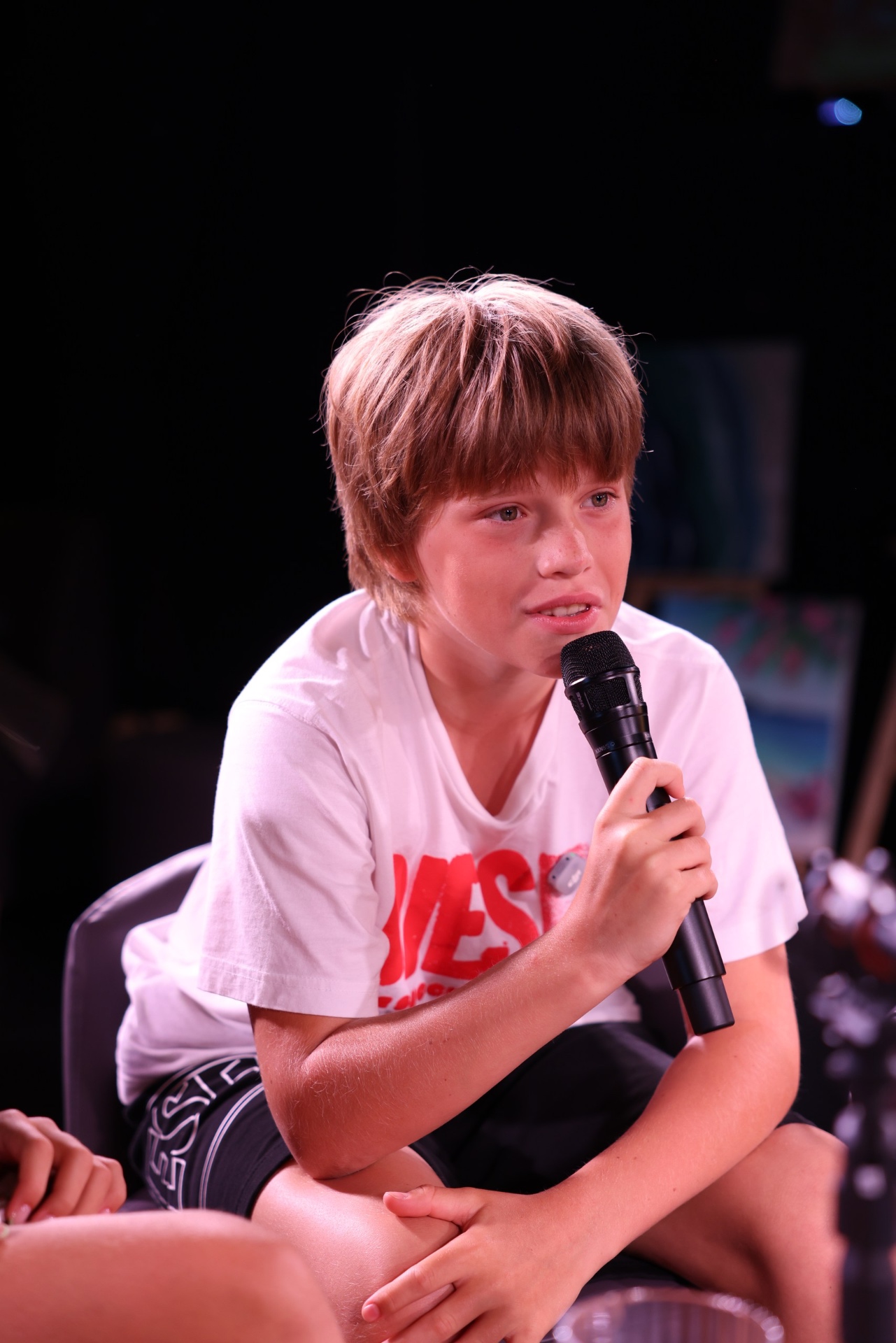 First season participant speaking into a microphone during a recording